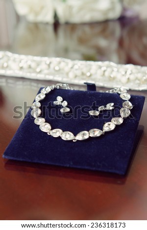 elegant crystal wedding set of jewelry on blue support