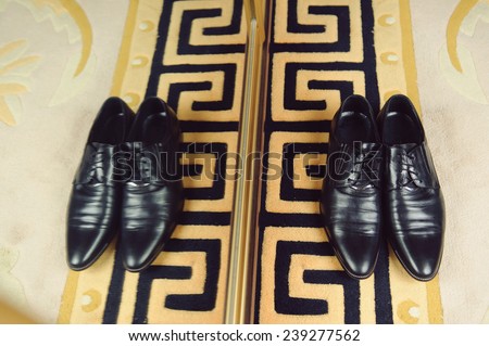 groom\'s shoes at wardrobe with mirror