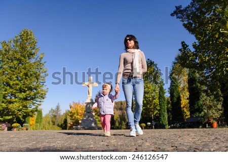 mother and daughter walking at church yard