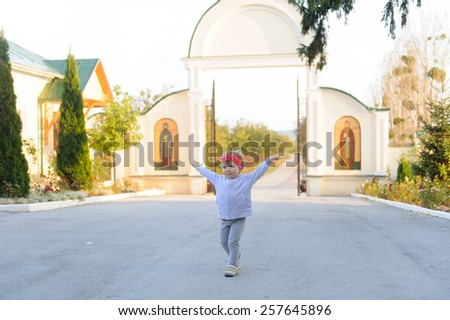 carefree girl running at church yard