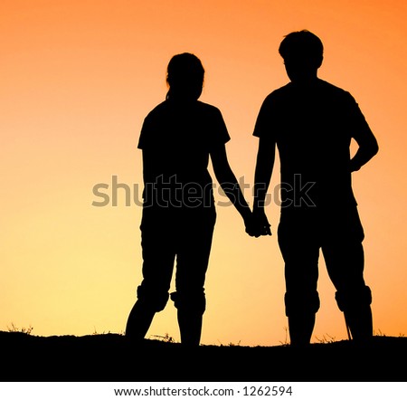 Holding Hands In Sunset. hands during sunset time