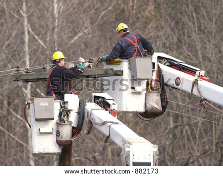 Two Electrical workers in Cherry Picker fixing cables