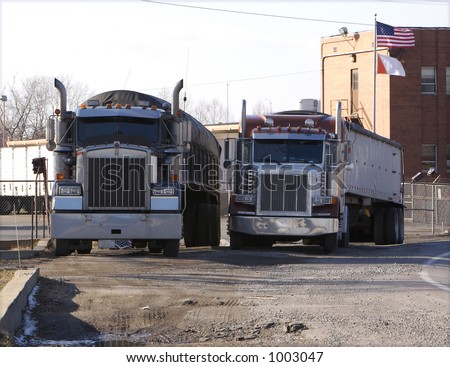 Two Parked Semi Trucks (Tractor Trailers)