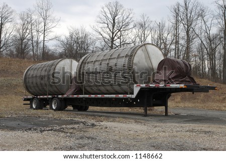 Flatbed loaded with industrial tank or equipment