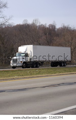 White Semi Tractor Trailer Truck on the Highway