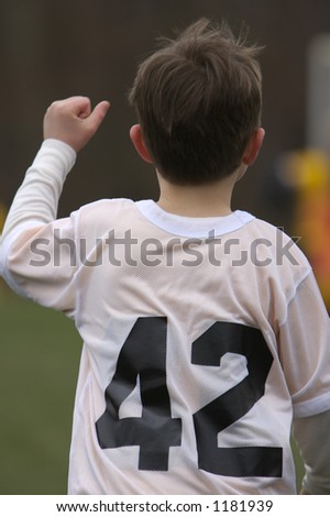 Young Boy Playing Soccer - Cheering after Goal