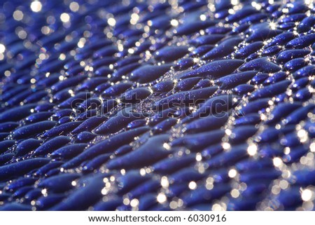 morning dew on a metallic blue truck with shallow depth of field, could be used as a cd cover