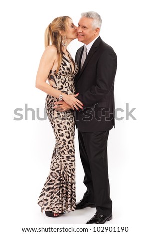 Attractive middle age couple in formal wear in an affectionate pose isolated on a white background.