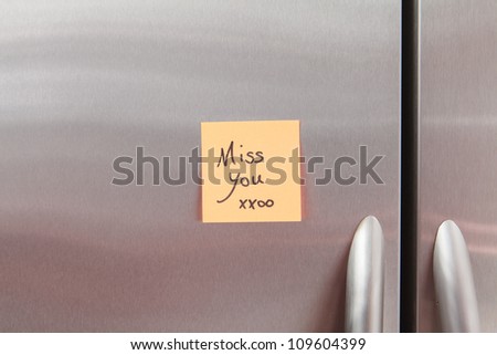 Miss you Post It Note on a home kitchen refrigerator.