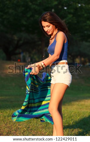 Beautiful multicultural young college woman enjoying outdoor campus life.