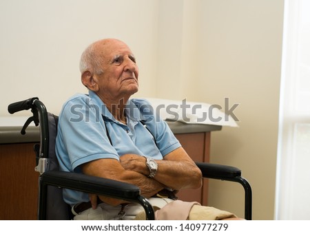 Elderly handicapped 80 plus year old man in a doctor office setting.