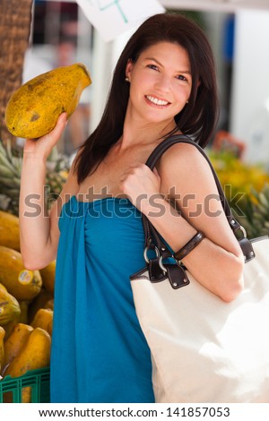 Beautiful woman outdoor lifestyle portrait in a fruit market.