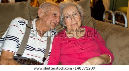 Elderly 80 plus year old couple in an affectionate pose.