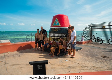 KEY WEST, FLORIDA JULY 25: Visitors being photographed at the popular Southernmost Point on July 25, 2011 in Key West.