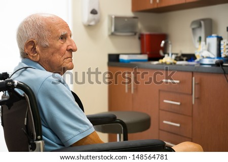 Elderly handicapped eighty plus year old man in a doctor office setting.