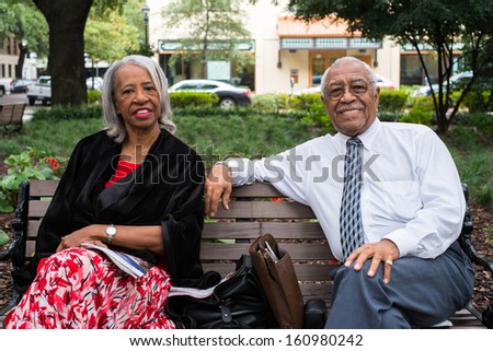 SAVANNAH, GEORGIA OCTOBER 8: Unidentified retired African American couple enjoying the afternoon at one of the popular city squares in historical Savannah on October 8, 2013.