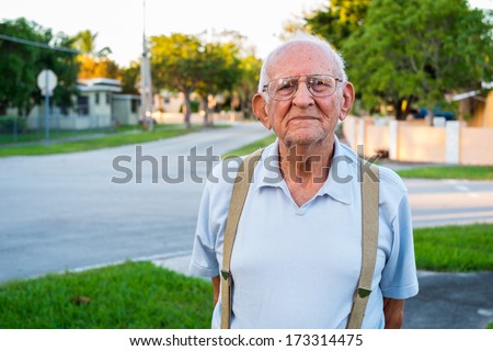 Elderly eighty plus year old man outdoors in a home setting.