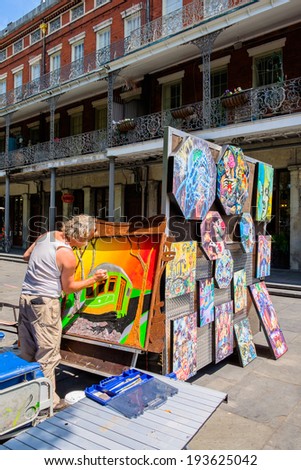 NEW ORLEANS, LOUISIANA USA - MAY 1, 2014: Unidentified artist creating a new work outside the popular Jackson Square in New Orleans, Louisiana.