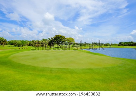 Golf course landscape viewed from behind the putting green.