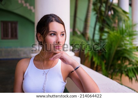 Beautiful young woman in a outdoor courtyard setting.