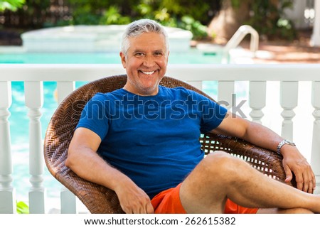 Handsome unshaven middle age man outdoor portrait in a home setting.
