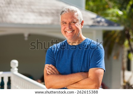 Handsome unshaven middle age man outdoor portrait in a home setting.