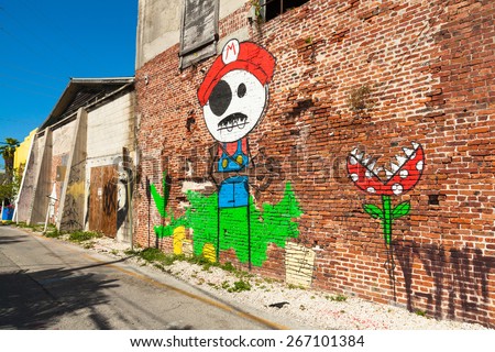 Key West, Florida USA - March 2, 2015: A vintage brick building covered with graffiti art in the Bahama Village District of Key West.
