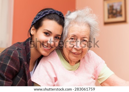 Elderly 80 plus year old grandmother with granddaughter in a home setting.