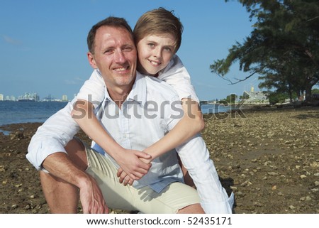 Father and son lifestyle image with Miami\'s Biscayne Bay in the background.