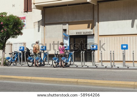 NICE, FRANCE - JULY 14:Unidentified tourists rent bicycles on July 14 in Nice, France.  Green Conservation programs expand in France like the popular Velobleu bicycle rental program.