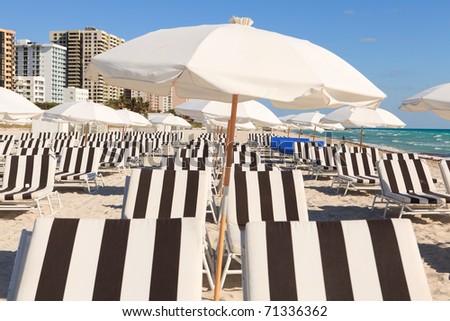Colorful umbrellas and lounge chairs on Miami\'s South Beach.