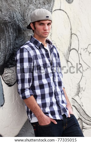 Handsome young man in a urban fashion pose in a downtown area.