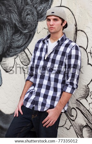 Handsome young man in a urban fashion pose in a downtown area.