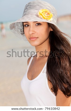 Beautiful young woman enjoying the South Beach shoreline in Miami.