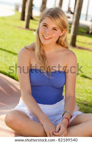 Pretty young blond woman enjoying South Pointe Park in Miami Beach.