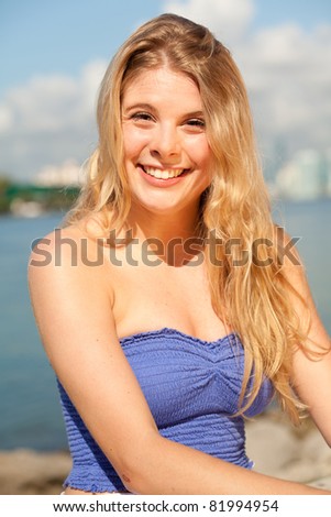 Pretty young blond woman enjoying South Pointe Park in Miami Beach.