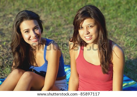 Pretty young female college roommates outdoors on a college campus.
