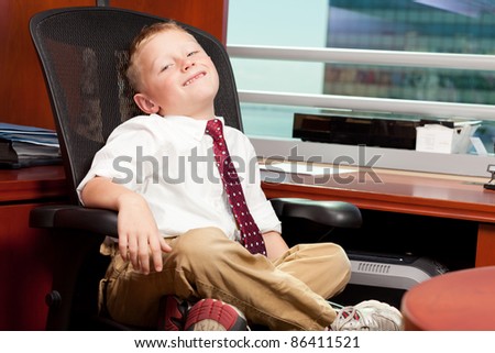 Cute boy with business attire in a corporate office.