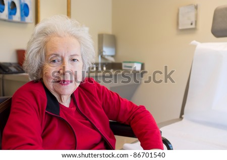 Elderly 80 plus year old woman with Alzheimer in a medical office setting.