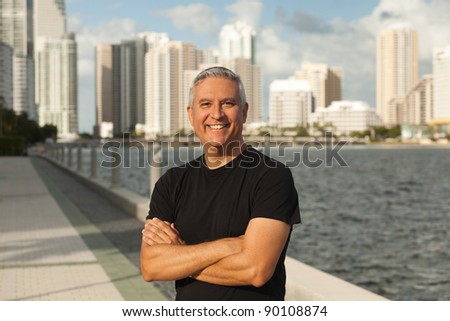 Handsome middle age man in an outdoor urban setting with Miami Biscayne Bay in the background.