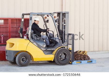 Warehouse Worker Driver In Uniform Driving Forklift Stacker Loader