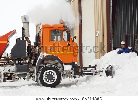 Snow cleaning on industrial area by means of the truck.