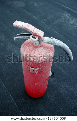 frosted fire extinguisher on floor