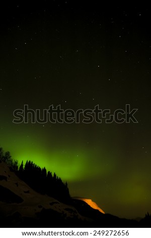 Aurora borealis (northern lights) and lots of stars around the constellation \