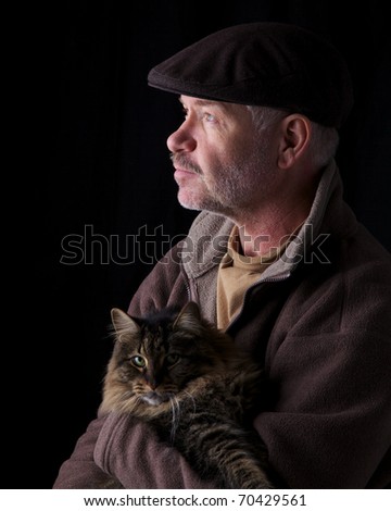Older gentleman holding his cat
