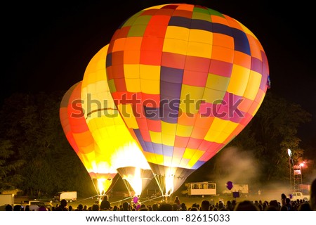 Hot Air Balloon festival with night glow and drifting smoke from fireworks.