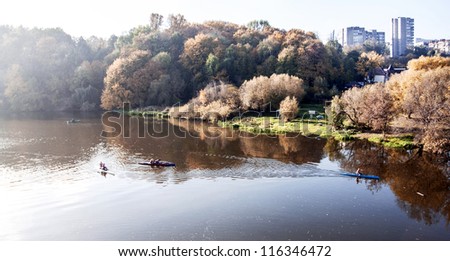 River morning landscape with kayaks and athletes on the river