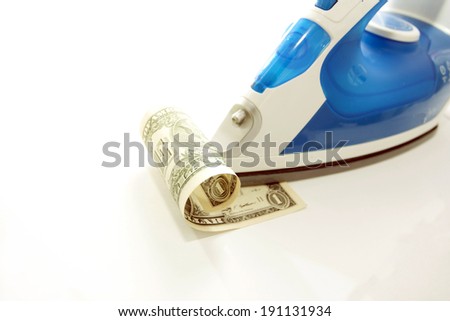 Dollar under the iron on a white background