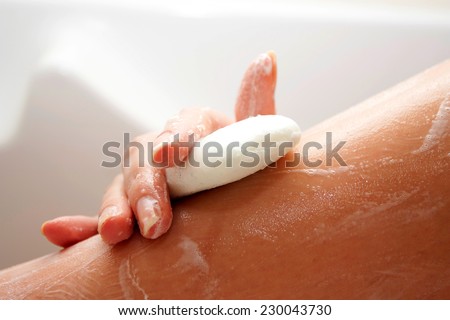 Washing of feet by soap in a bathroom with a skin