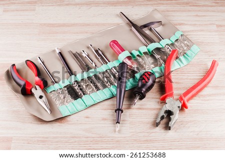 Set of various tools for repairs around the house on a background of wooden floor